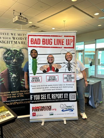 People pose for camera behind Bad Bug Lineup sign